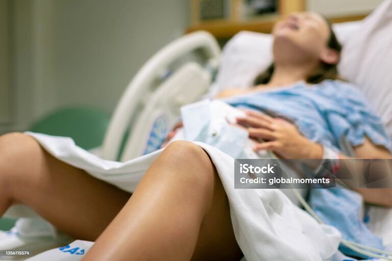 A woman screaming in pain from strong contractions. Childbirth